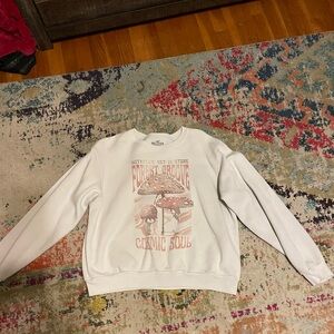 A white sweater very cute and has these cute designs on top